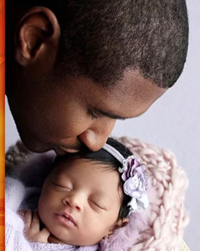 Usher Raymond IV kissing his new born daughter.